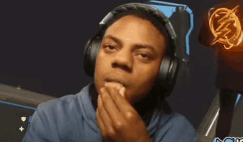a man wearing headphones with a lightning bolt on his shirt