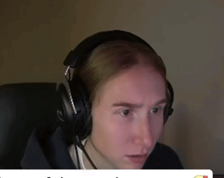 a man wearing headphones with a microphone looks at the camera
