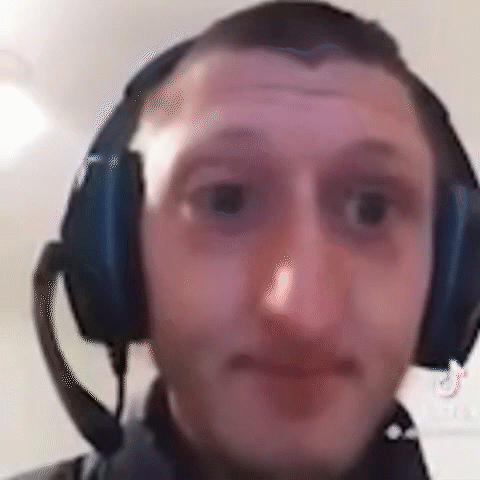 A Man Wearing Headphones With A Microphone On His Head . GIF