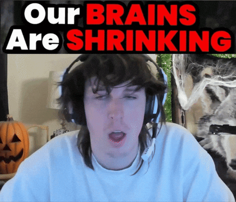A Man Wearing Headphones With A Sign That Says Our Brains Are Shrinking GIF