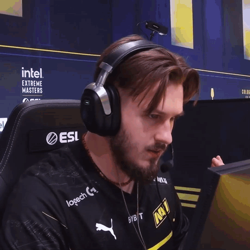 A Man Wearing Headphones With Intel Extreme Masters Written On The Back GIF