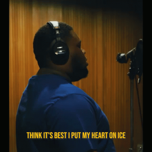 A Man Wearing Headphones With The Words Think It 'S Best I Put My Heart On Ice Above Him GIF