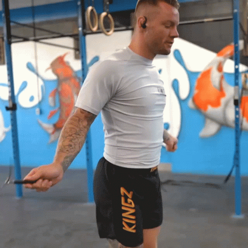 A Man Wearing Kingz Shorts Jumps A Rope GIF