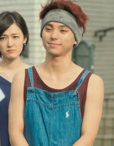A Man Wearing Overalls And A Headband Has A Polo Logo On His Shirt GIF