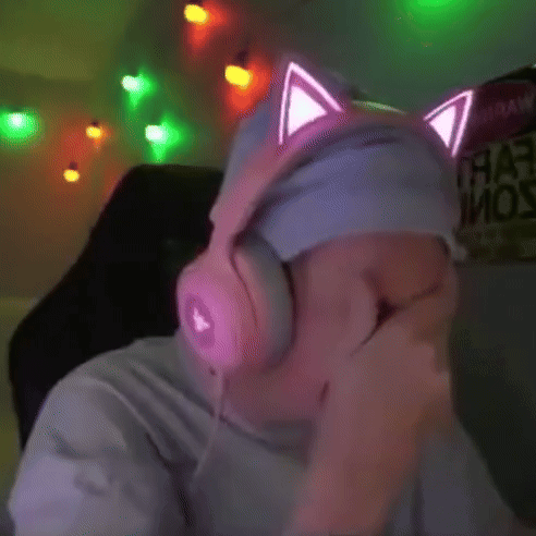 a man wearing pink headphones with cat ears on his headband