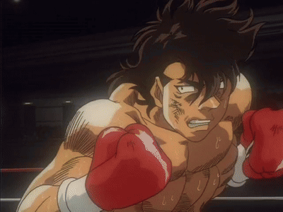 A Man Wearing Red Boxing Gloves In A Boxing Ring GIF