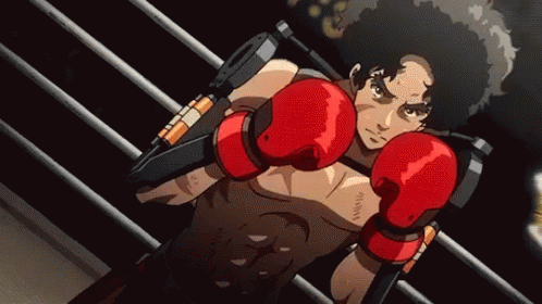A Man Wearing Red Boxing Gloves Is Standing In A Boxing Ring GIF
