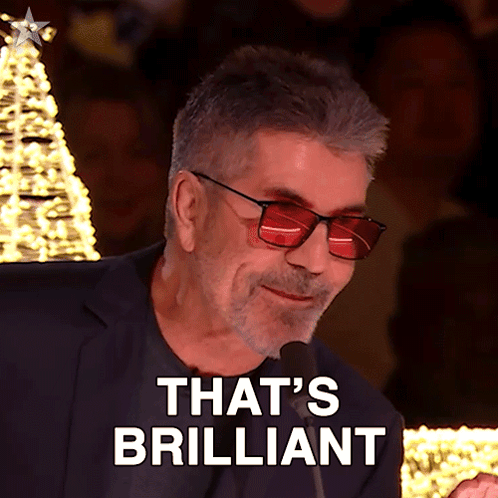 A Man Wearing Red Glasses And A Suit Says That 'S Brilliant GIF