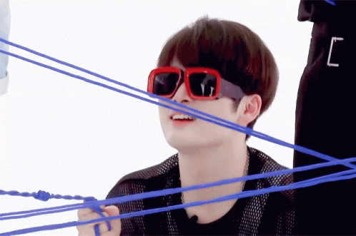 A Man Wearing Red Sunglasses Is Surrounded By Blue Rope GIF