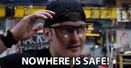 A Man Wearing Safety Glasses And A Hat Is Saying `` Nowhere Is Safe ! '' GIF
