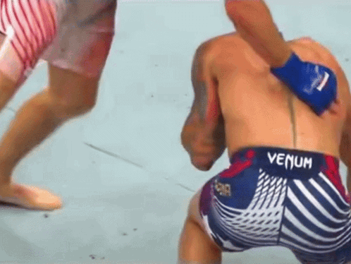 A Man Wearing Shorts That Say Venum On The Back GIF
