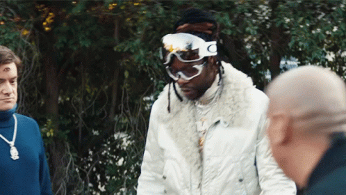 A Man Wearing Ski Goggles With The Letter C On The Side GIF