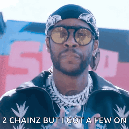 A Man Wearing Sunglasses And A Bandana Has The Words 2 Chainz But I Got A Few On Below Him GIF
