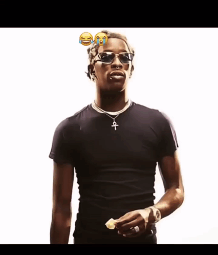 A Man Wearing Sunglasses And A Black Shirt Has A Cross Necklace GIF
