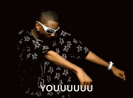 A Man Wearing Sunglasses And A Black Shirt Is Dancing On A Stage . GIF