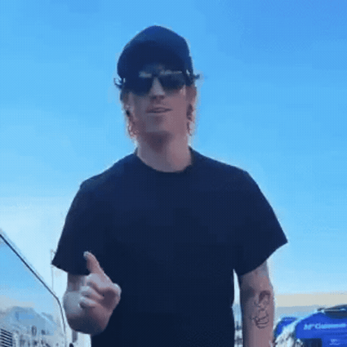 A Man Wearing Sunglasses And A Black Shirt Is Giving A Thumbs Up GIF
