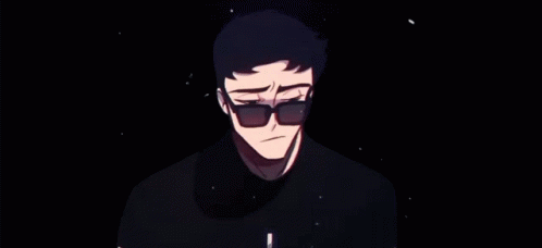 A Man Wearing Sunglasses And A Black Shirt Is Standing In A Dark Room . GIF
