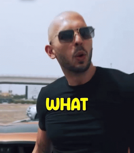 A Man Wearing Sunglasses And A Black Shirt That Says What On It GIF
