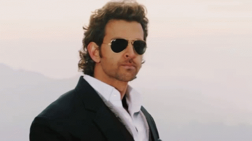 A Man Wearing Sunglasses And A Black Suit GIF