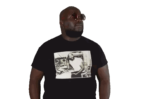 a man wearing sunglasses and a black t-shirt with a picture of a man playing a piano