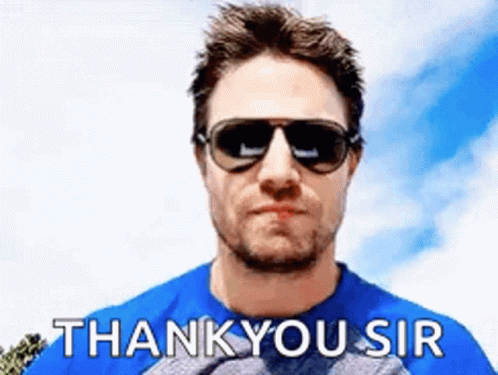 A Man Wearing Sunglasses And A Blue Shirt Is Giving A Thank You Sir Sign . GIF