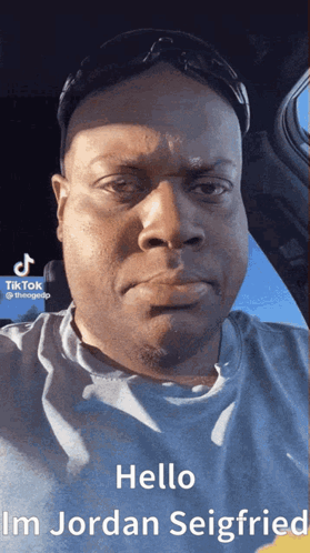 A Man Wearing Sunglasses And A Blue Shirt Says Hello Im Jordan Seigfried GIF