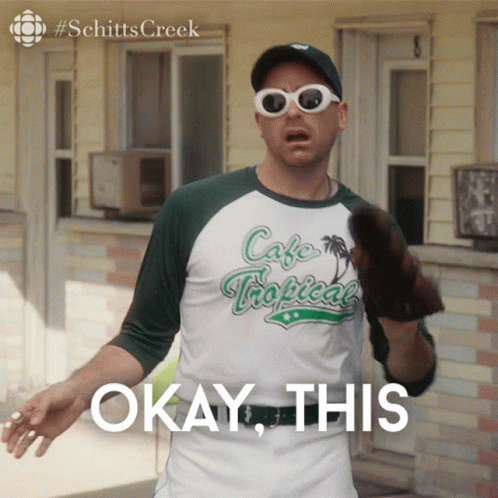 A Man Wearing Sunglasses And A Cafe Tropical Shirt Says " Okay This " GIF