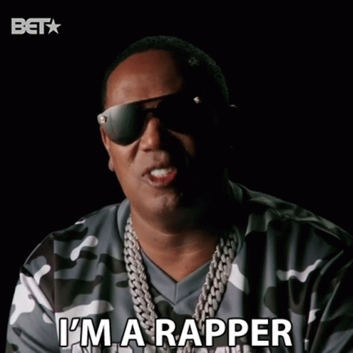 A Man Wearing Sunglasses And A Camo Shirt Is Saying I 'M A Rapper GIF
