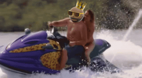 A Man Wearing Sunglasses And A Crown Rides A Jet Ski GIF