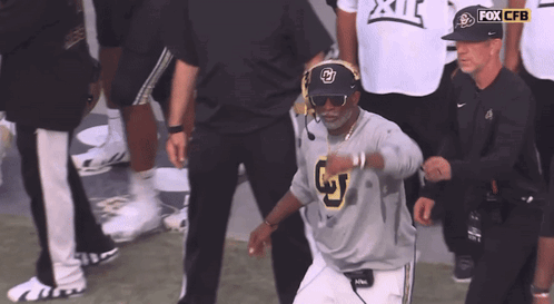 A Man Wearing Sunglasses And A Fox Cbs Hat GIF
