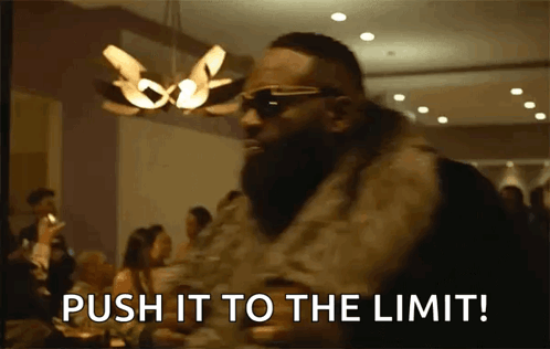 A Man Wearing Sunglasses And A Fur Coat Says Push It To The Limit GIF