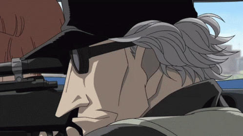 a man wearing sunglasses and a hat is holding a rifle