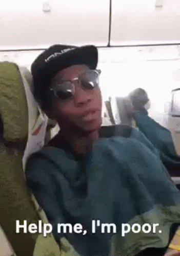 A Man Wearing Sunglasses And A Hat Is Sitting On An Airplane And Making A Funny Face . GIF