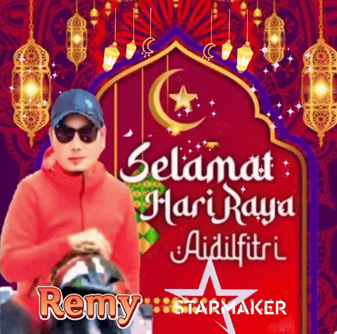 A Man Wearing Sunglasses And A Hat Is Standing In Front Of A Red Sign That Says Selamat Hari Raya Aidilfitri GIF