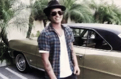 A Man Wearing Sunglasses And A Hat Is Standing Next To A Car GIF