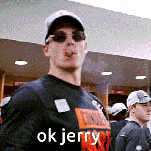 A Man Wearing Sunglasses And A Hat Smoking A Cigarette With The Words Ok Jerry Above Him GIF
