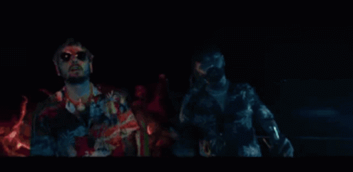 A Man Wearing Sunglasses And A Hawaiian Shirt Is Making A Funny Face With His Hands Outstretched . GIF