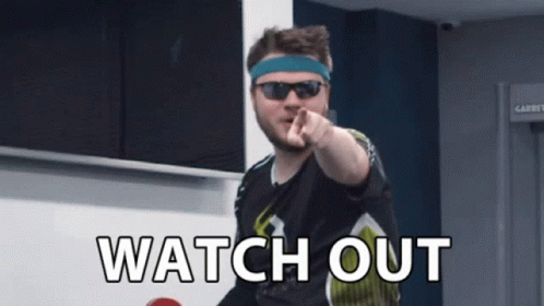 A Man Wearing Sunglasses And A Headband Points At The Camera With The Words Watch Out Written Below Him GIF