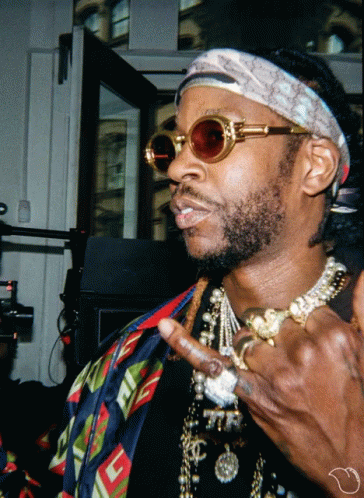 A Man Wearing Sunglasses And A Headband With A Gucci Logo GIF