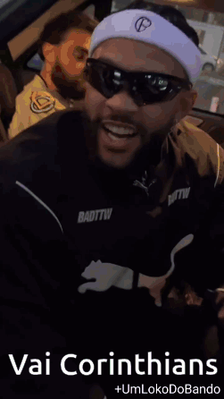 a man wearing sunglasses and a headband with the words vai corinthians on it