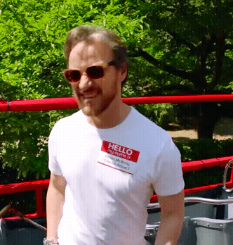 A Man Wearing Sunglasses And A Hello My Name Is Tag On His Shirt GIF