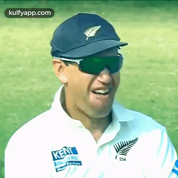 A Man Wearing Sunglasses And A Kent Shirt Smiles For The Camera GIF
