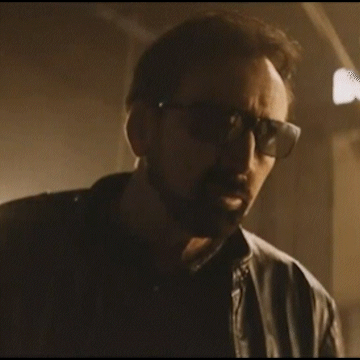 A Man Wearing Sunglasses And A Leather Jacket Is Looking At The Camera GIF