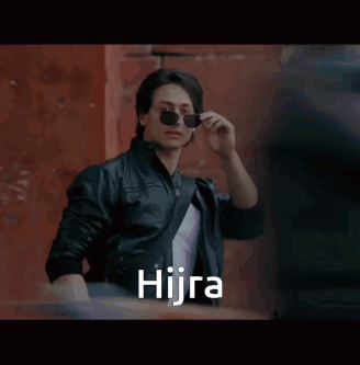 A Man Wearing Sunglasses And A Leather Jacket With The Word Hijra Written On The Bottom GIF