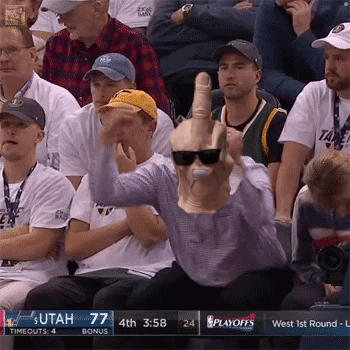 A Man Wearing Sunglasses And A Mask Giving The Middle Finger At A Basketball Game GIF
