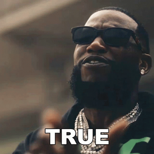 A Man Wearing Sunglasses And A Necklace Has The Word True Above Him GIF
