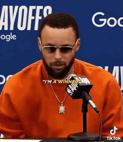 A Man Wearing Sunglasses And A Necklace Says " I 'M A Winner " In Front Of A Nba Microphone GIF