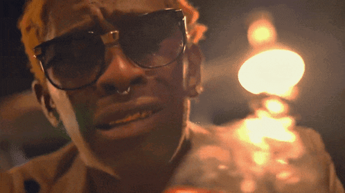 A Man Wearing Sunglasses And A Nose Ring GIF
