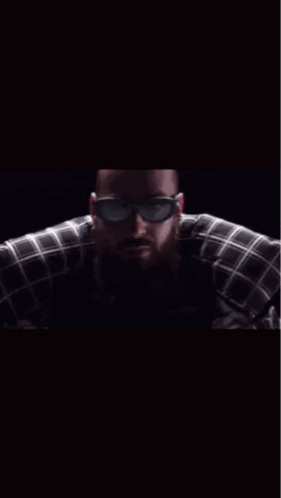 A Man Wearing Sunglasses And A Plaid Shirt With The Words Hey Le Brother On The Bottom GIF