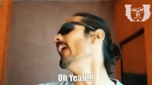 A Man Wearing Sunglasses And A Ponytail Is Saying Oh Yeah !!! GIF